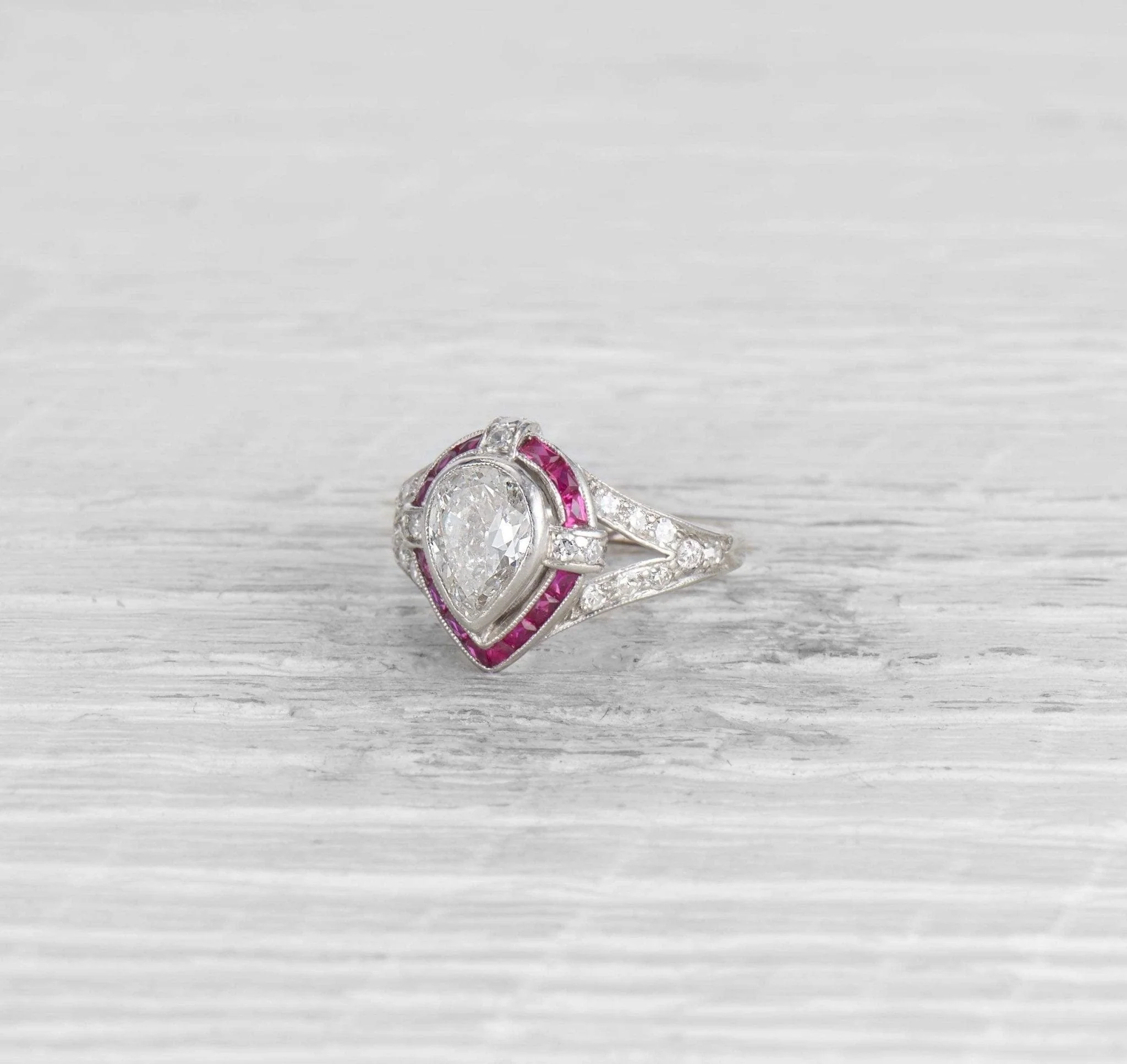 1.00 CARAT ART DECO PEAR DIAMOND AND RUBY ENGAGEMENT RING