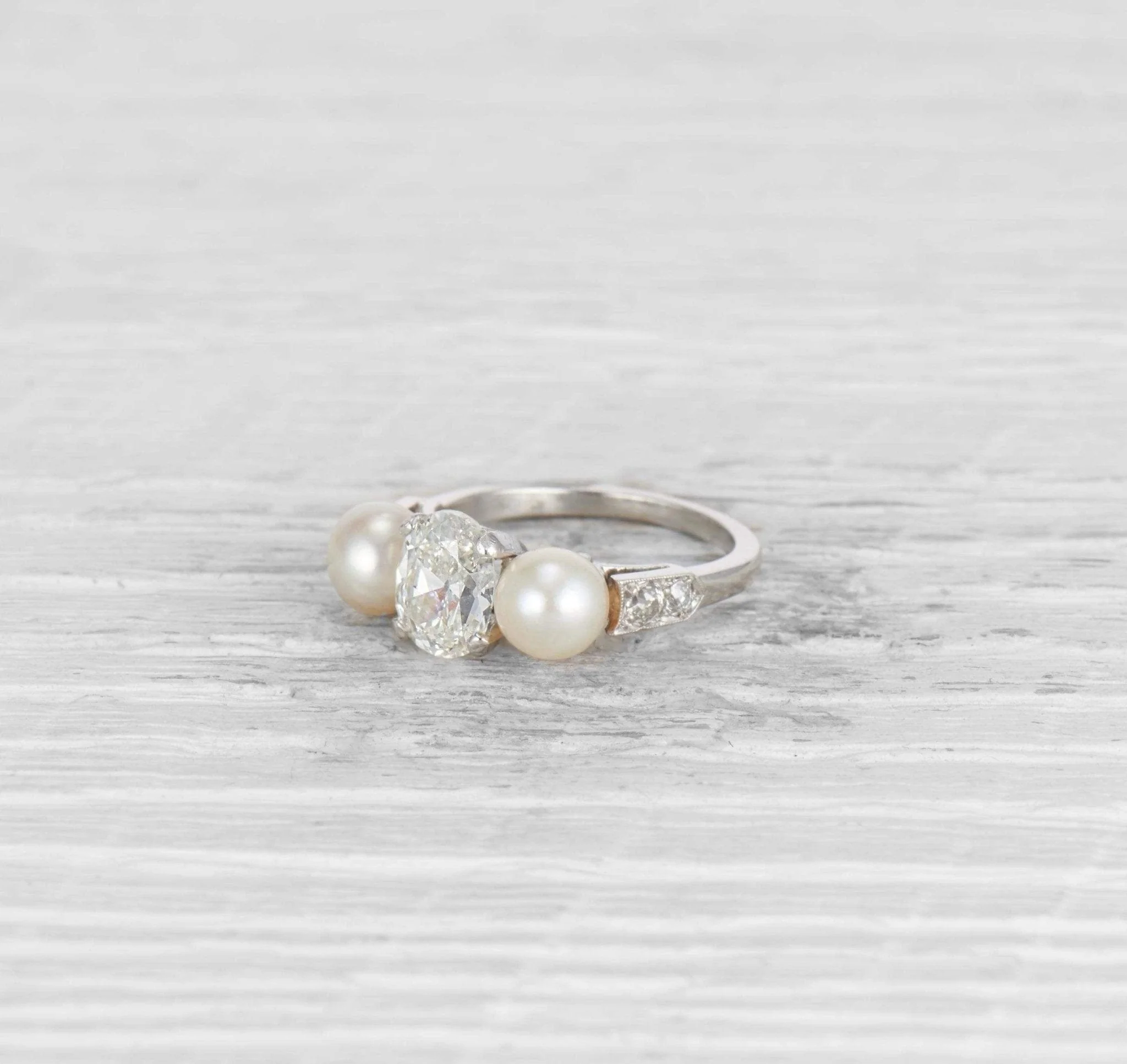 1.29 CARAT EARLY ART DECO DIAMOND AND CULTURED PEARL THREE STONE RING