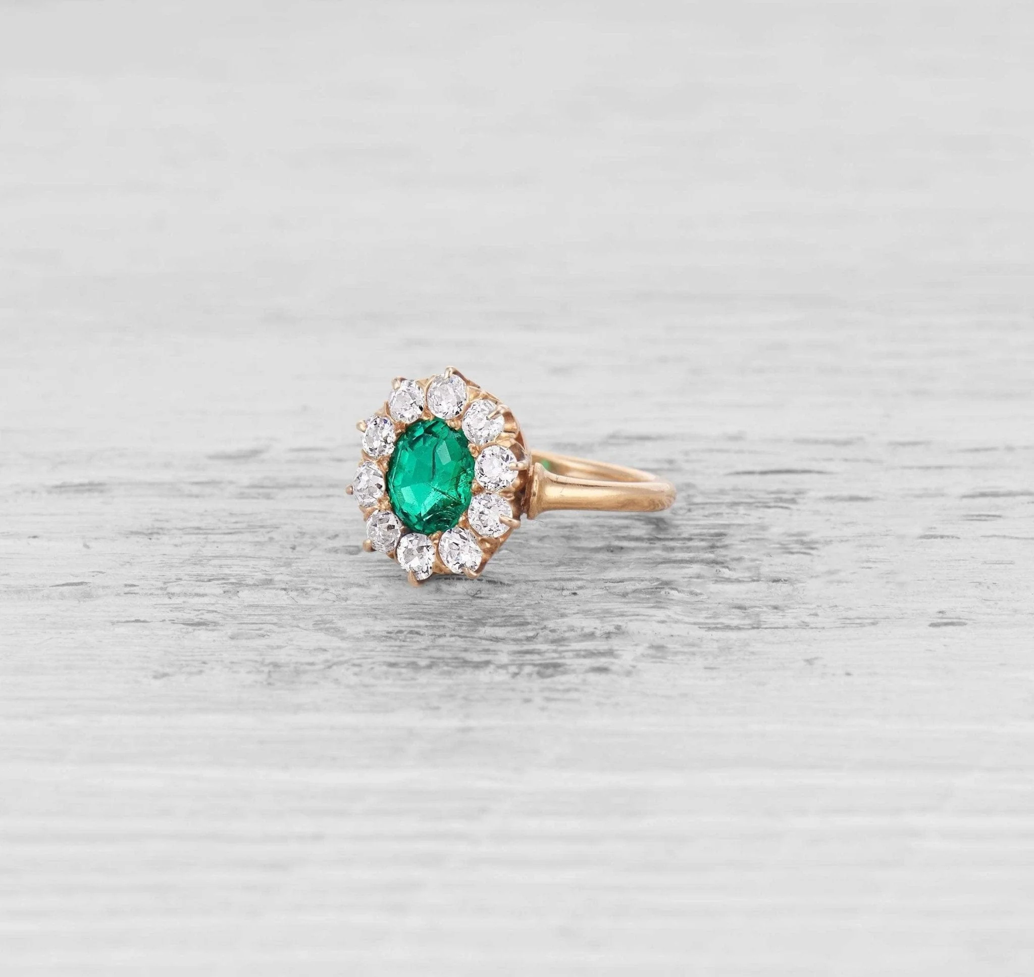 EMERALD AND DIAMOND CLUSTER ENGAGEMENT RING